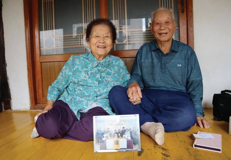 상림리 어르신이 가족 사진을 보여주며 활짝 웃고 있다. 경북개발공사 제공.