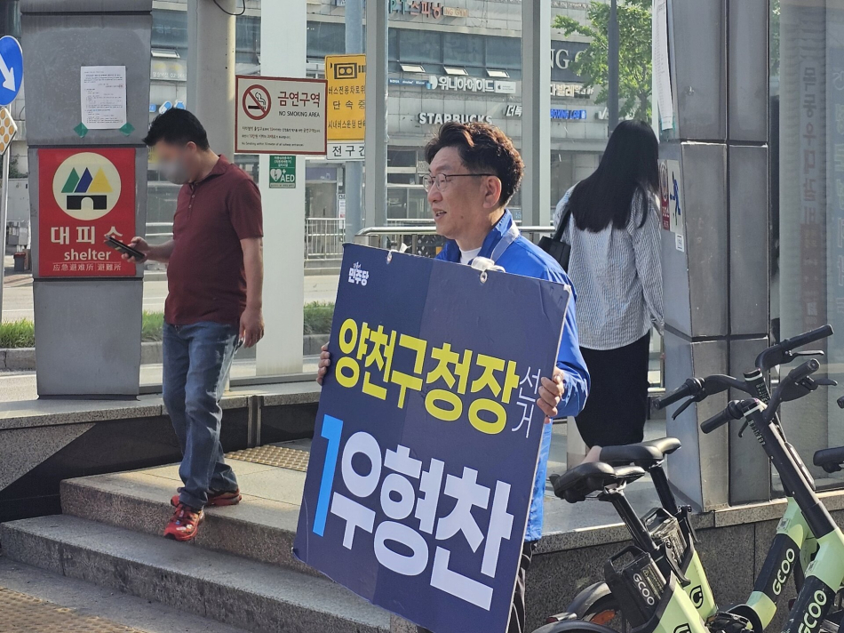 우형찬 더불어민주당 양천구청장 후보가 서울 양천구 한 지하철역 앞에서 시민들에게 인사하고 있다. 우 후보 캠프 제공