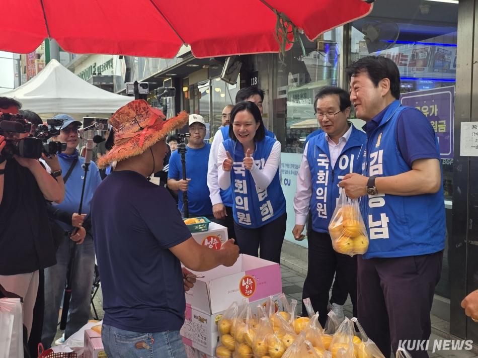 경기 평택을 국회의원 재선거에 출마하는 김용남 더불어민주당후보(사진 오른쪽)가 안중시장 과일 상인과 안부 인사를 나누고 있다. 김미경 기자