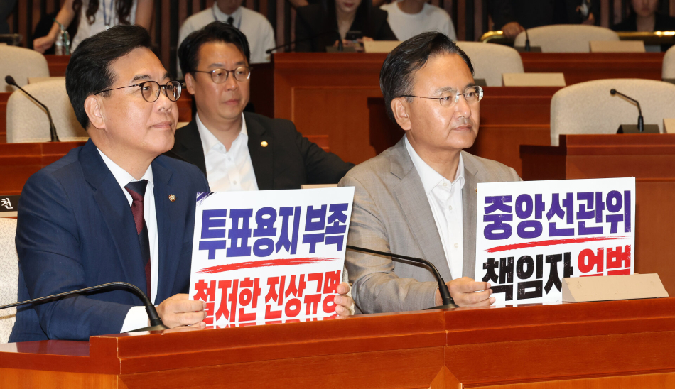 송언석 국민의힘 원내대표와 유상범 원내운영수석부대표가 4일 국회에서 열린 긴급 의원총회에서 투표용지 부족 사태와 관련한 중앙선관위 규탄 손팻말을 들고 있다. 연합뉴스